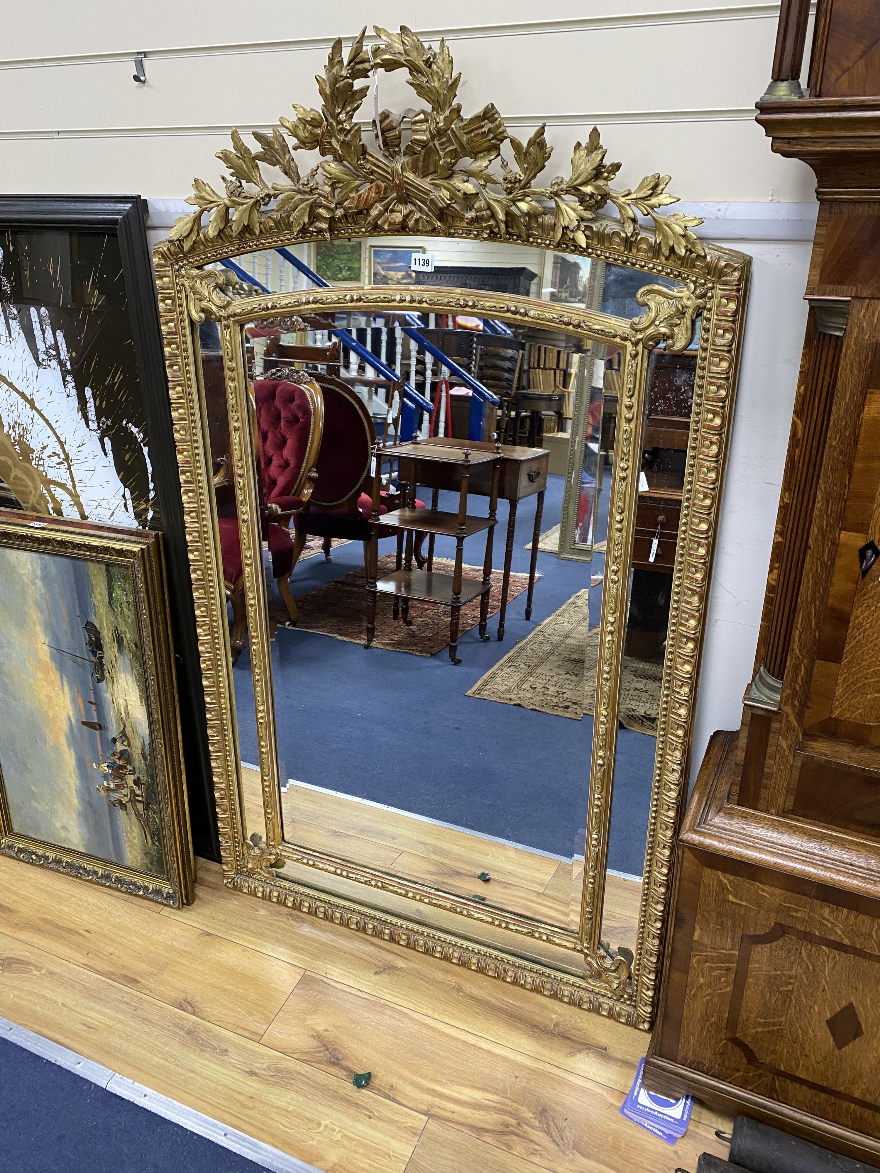 A 19th century giltwood and gesso overmantel mirror with Olympic Torch & Laurel Crown, side cushions with decorated bead detail, width 92cm, height 153cm